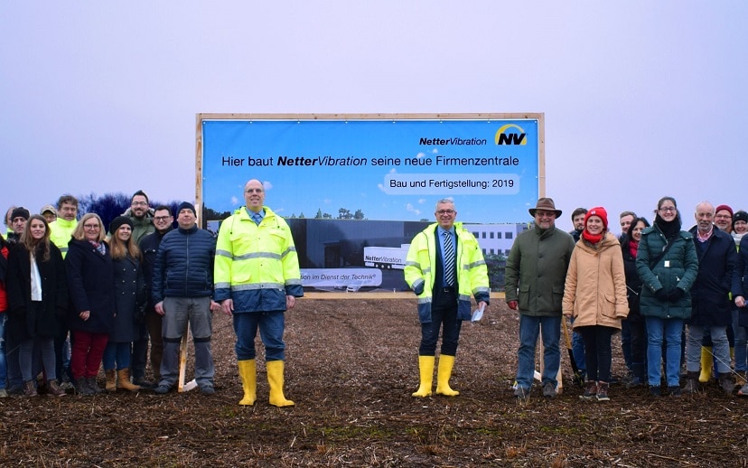 Achim Werkmann und Thomas Reis mit Ihrem Team vor dem Bauschild für den Zentrale Neubau