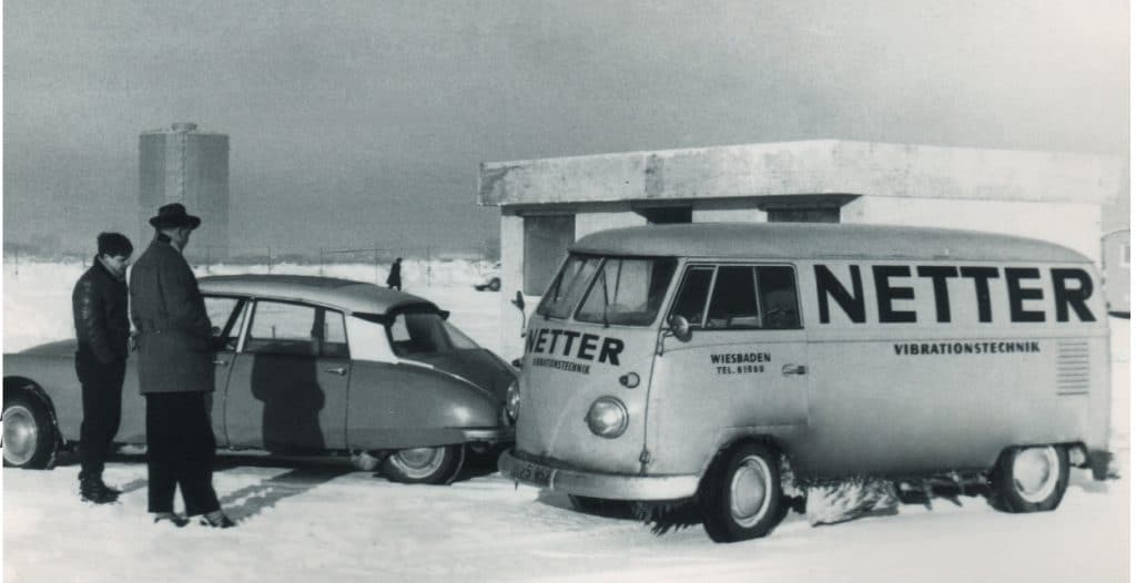 Bild aus den 1953/54 Jahren. Ein VW Bus mit der Aufschrift NETTER Vibrationstechnik Wiesbaden und davor ein Citroen DS mit 2 Herren im Schnee.
