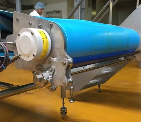 Ende eines blauen Förderbandes in einer Industriehalle