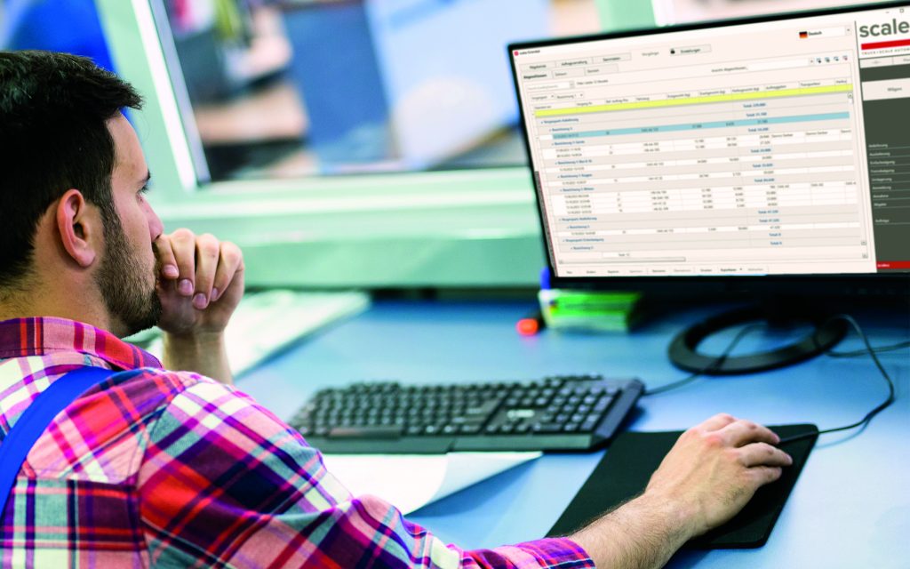 Mann sitzt am Schreibtisch, mit einer Tastatur und einem Bildschirm vor sich. Auf dem Bild ist eine Scaleo Software sichtbar.
