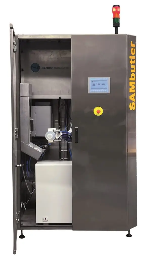 Schrank auf Metall mit einem Display und Notausknopf. die linke Schranktür ist offen udn man sieht die Maschine im Inneren des Schrankes.