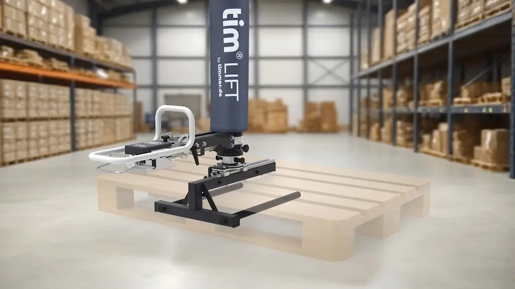 Eine Hebehilfe, die mit einem Gabelaufsatz eine Palette hebt. Im Hintergrund eine Lagerhalle