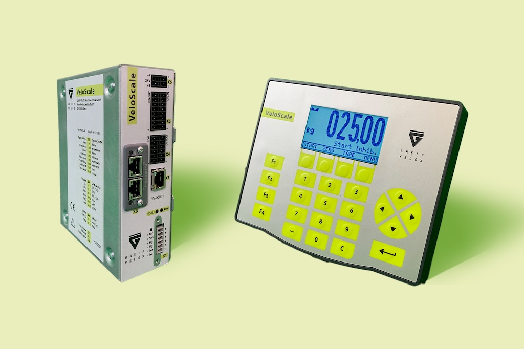 Zwei Komponenten des Velo Scale. Links eine Box mit verschiedenen Steckanschlüssen. Rechts ein Kasten mit Zahlen und Tasten und einem Display mit Zahlen