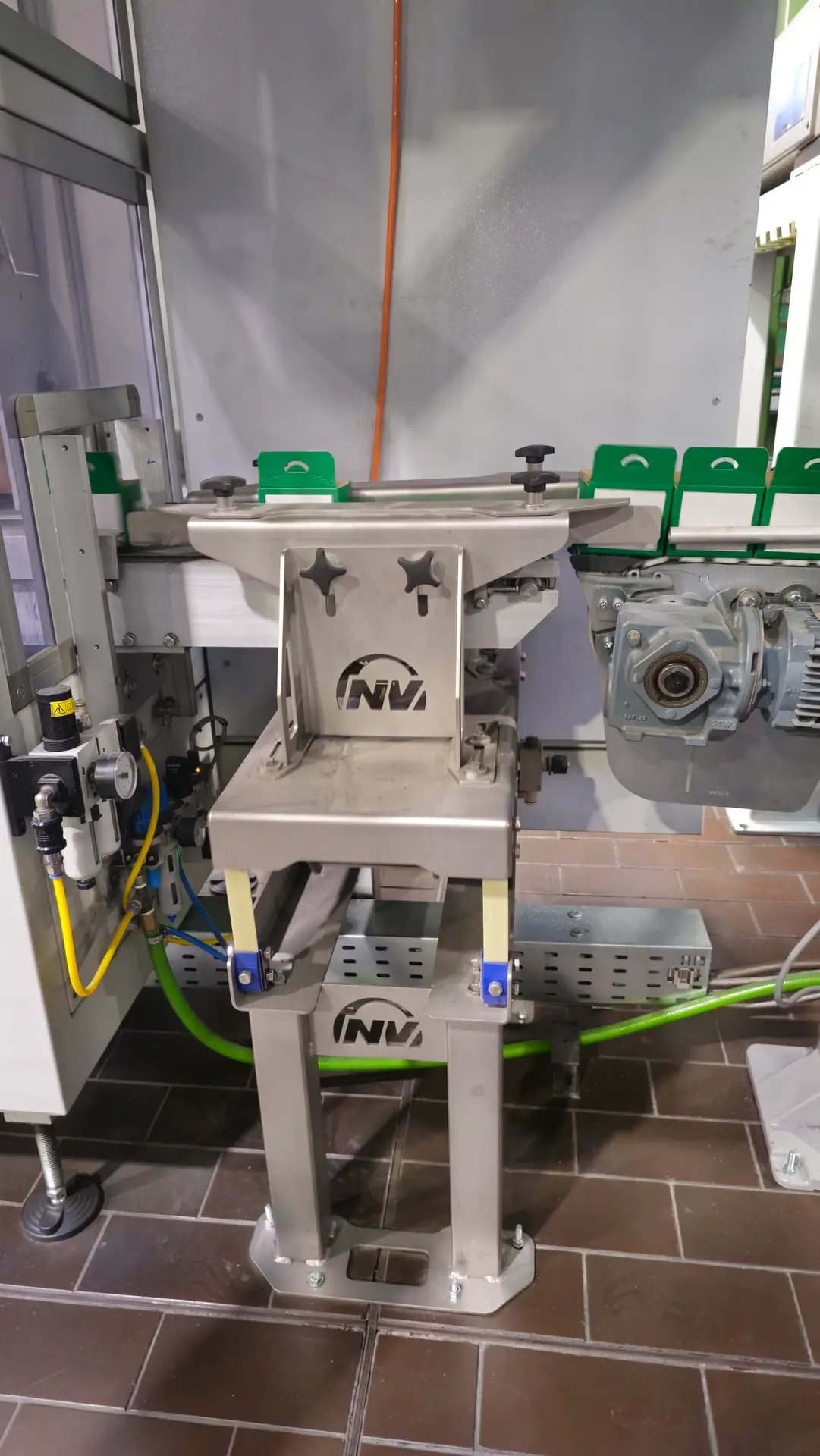 Vibrationstisch von NetterVibration im Übergabebereich einer automatisierten Verpackungslinie für Schrauben.